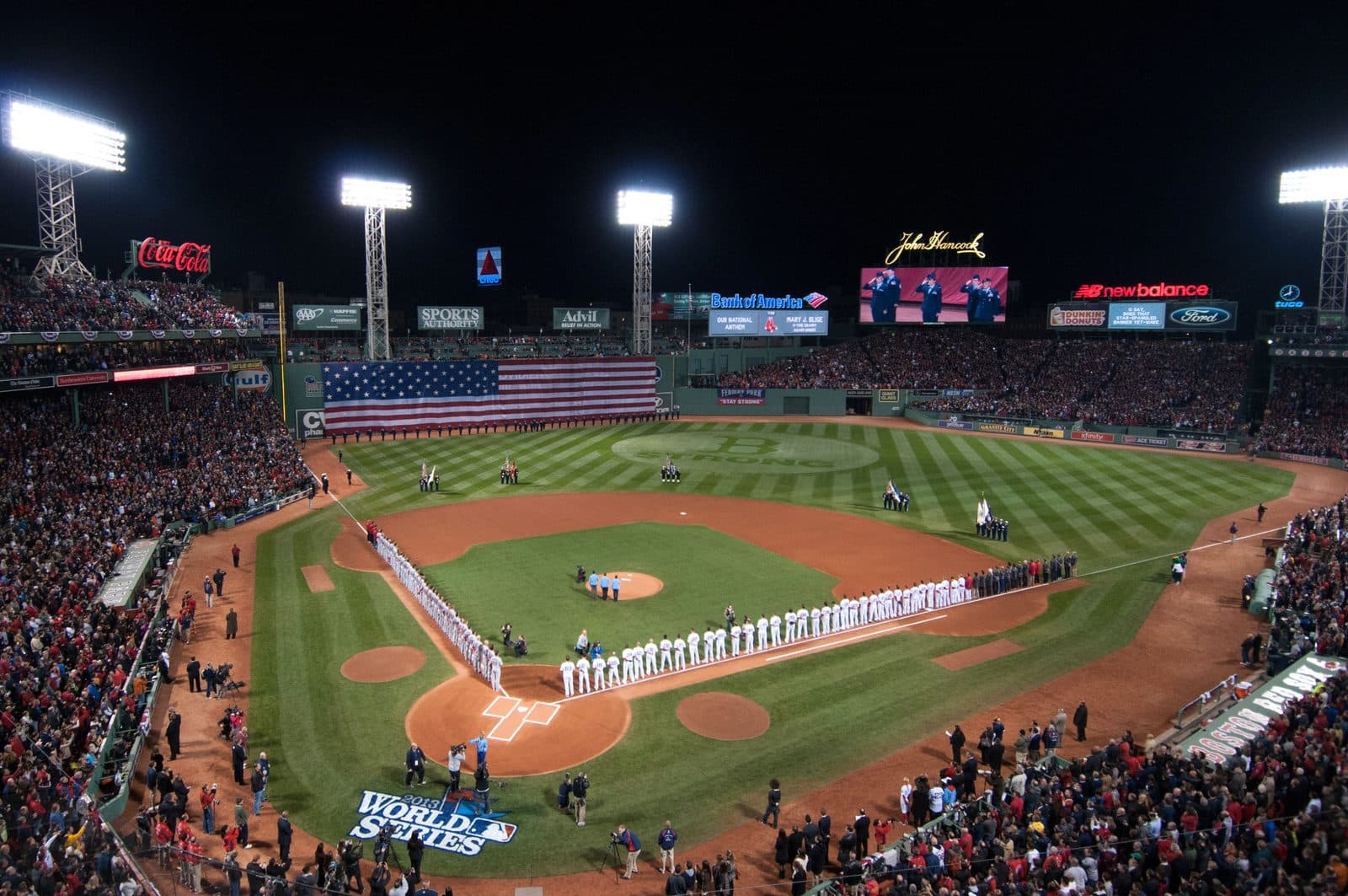 Fenway Park, 2013 — 10/24/2013 - Airmen from Hanscom Air Force Base , also captured on the centerfield Jumbotron, line the flag-draped left field wall at Fenway Park in Boston during the World Series
