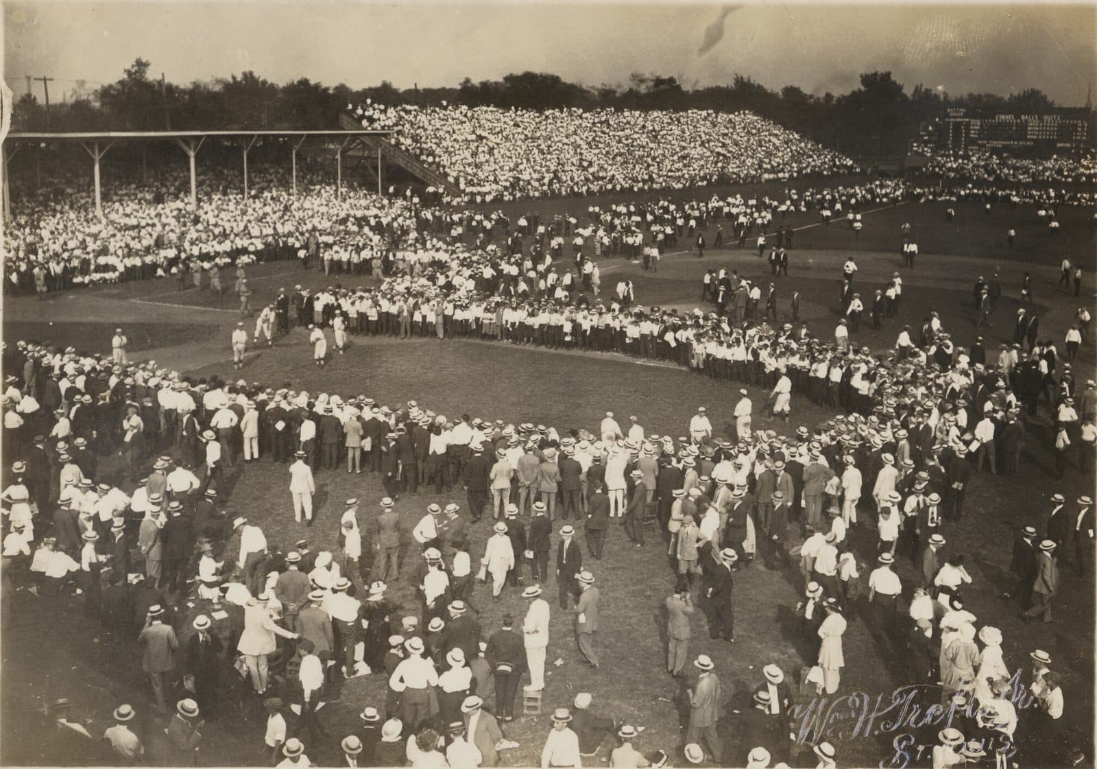 Robison Field, 1912 — Title: Crowd gathered around St. Louis Cardinals baseball players during the pre-game warm-ups at Robison Field.